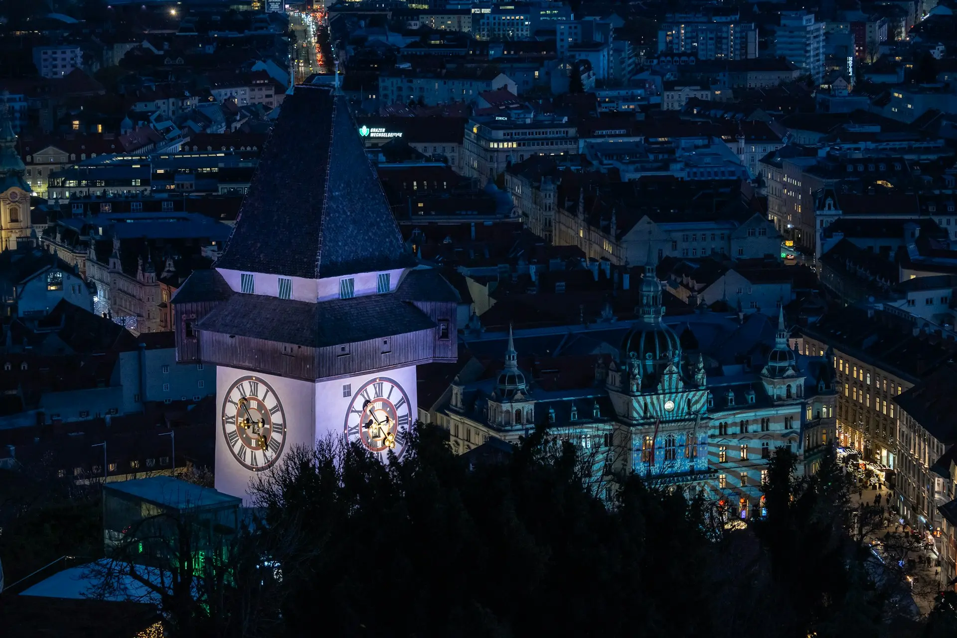 a clock tower in the middle of a city at night