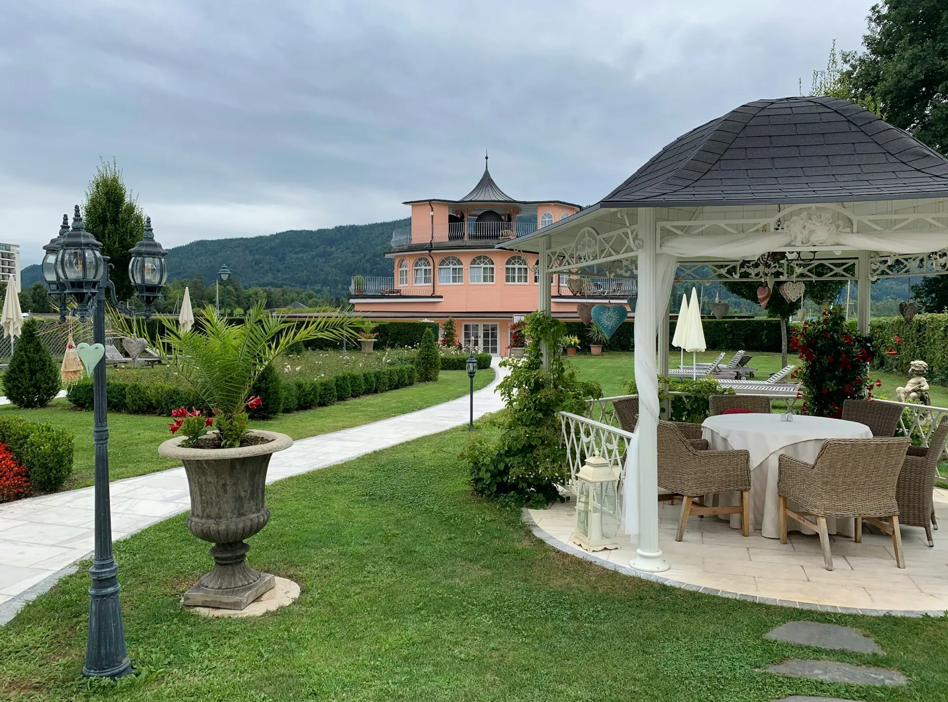 a gazebo sitting in the middle of a lush green yard
