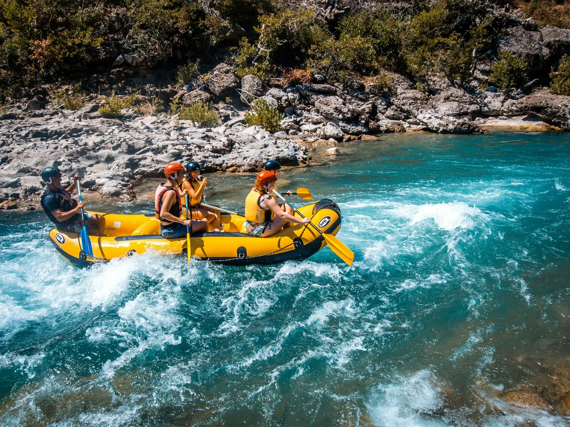 a group of people riding on the back of a raft